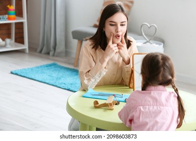 Speech Therapist Working With Cute Girl In Clinic