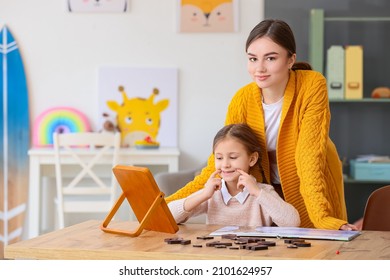 Speech Therapist Working With Cute Girl In Clinic