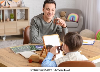 Speech therapist working with little boy in office - Shutterstock ID 2092231102
