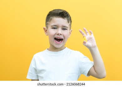 Speech Therapy. Toddler Boy Says The Letter A. Classes With A Speech Therapist. Boy On Isolated Yellow Background