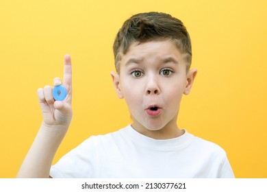 Speech Therapy. Toddler Boy Says The Letter O. Classes With A Speech Therapist. Boy On Isolated Yellow Background