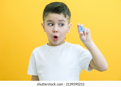 Speech Therapy. Toddler Boy Says The Letter O. Classes With A Speech Therapist. Boy On Isolated Yellow Background