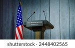 Speech tribune for government representative of the United States or politician in the White House in press conference hall. Podium debate stand with microphones on stage. Backdrop with American flag.