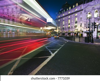 Speed Blur Of London Bus In Piccadilly Circus At Night