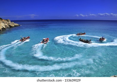Speed boat doing circle on clear blue water
