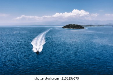 Speed boat faster movement on the water top view. Speedboat wave speed water. Speedboat movement on the water. Speedboat on dark blue water aerial view. Lichadonisia in North Evia, Greece