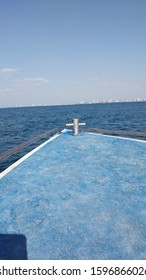 Speed Boat Front And Small Building Skyline