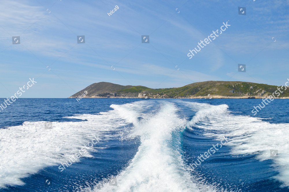 Speed boat wake at Adriatic sea near Vis island coast with Bisevo ...