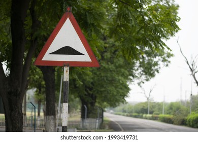 Speed Breaker Warning Road Sign In A Street.