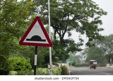 Speed Breaker Warning Road Sign In A Street.