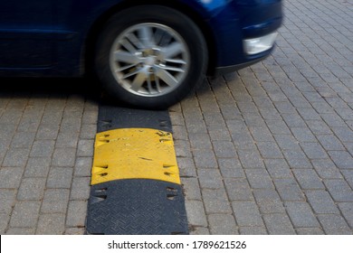A speed bump generally slows traffic, giving both people and cars time to react  Car in blur