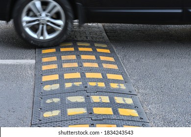 Speed bump on asphalt road when and car