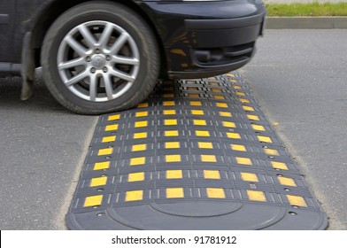 Speed bump on a road when and car