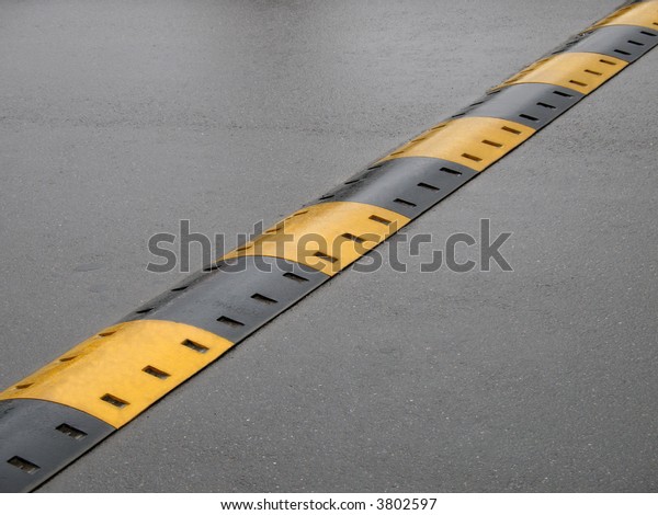 Speed Bump On Wet Road Stock Photo (Edit Now) 3802597