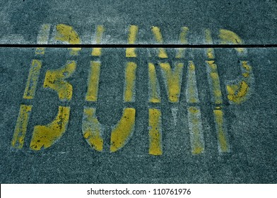 Speed Bump Sign Painted On The Road