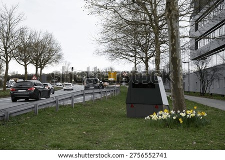 Speed camera installed by the roadside. Traffic monitoring device used to detect speeding vehicles and enforce road safety regulations.