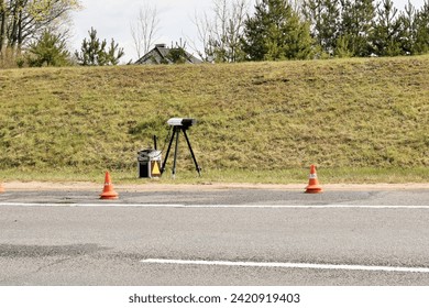 speed camera stands on the side of a freeway
