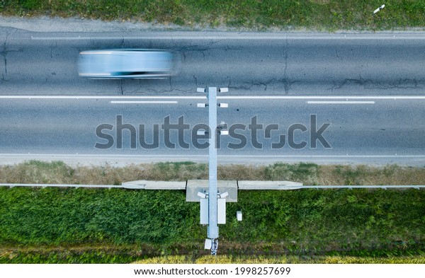 Speed control at the road. The speed camera takes photos\
and videos of vehicles. Speed limit. VÉDA, traffipax in Hungarian\
language. 