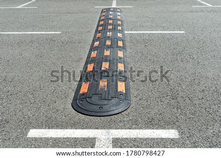 Speed hump on an asphalt. Traffic management and car driving
