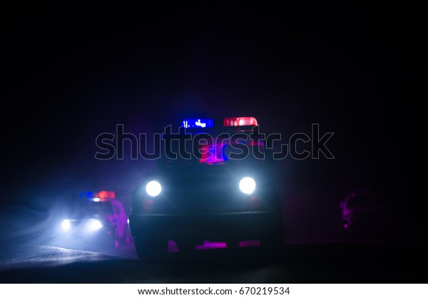 speed lighting of\
police car in the night on the road. Police cars on road moving\
with fog. Selective focus