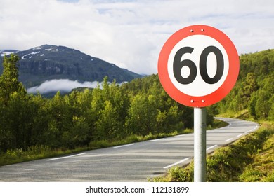 Speed limit sign by road in mountains
