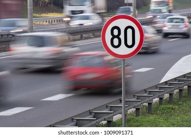 Speed Limit Sign With Car Passing In Motion Blur