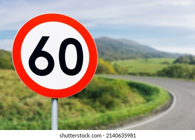 Speed limit sign with curvy road behind. Maximum sixty kilometers per hour. Safety on road background. White round sign red border line. Traffic ticket background. Speeding fine. Slow down on turn.