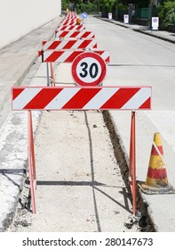 Speed Limit Sign And Many Hurdles In The Road Excavation