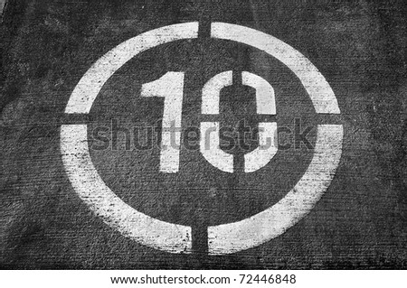 a speed limit sign painted on a road