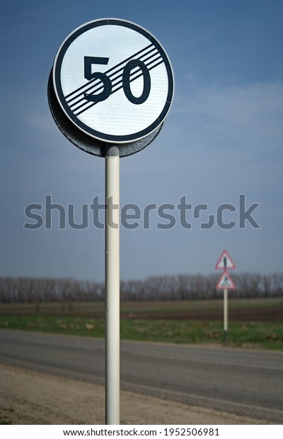 Speed limit zone ends sign on white background with\
clipping. Traffic signs. Spanish traffic signal: end of speed\
limited to 50 km per\
hour.