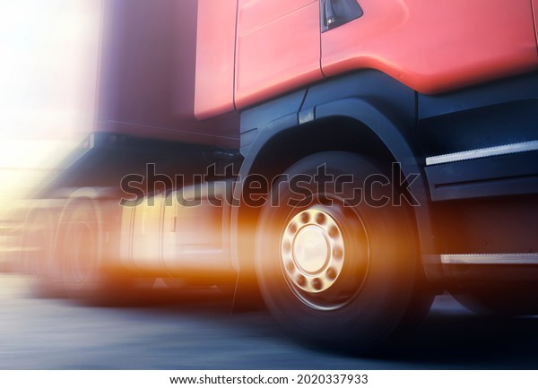 Speed Motion Blur of Semi Truck\
Driving on The Road. Truck Wheels Spinning. Industry Road Freight\
Truck. Logistics and Cargo Transport\
concept.	