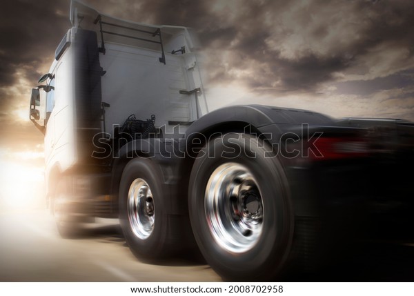 Speed Motion of Semi\
Truck Driving on Road at Sunset Sky. Road Freight Truck\
Transportation and\
Logistics.