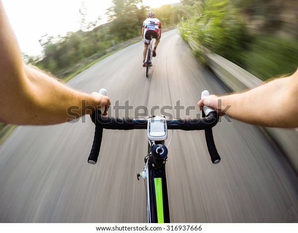 Speed on bike, Couple of cyclist during a road\
race. Pov, original point of\
view