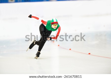 Speed skating young female sportsman during competition race 