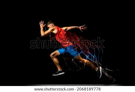 Speed and strength. Young male athlete, professional track athlete running isolated om black background. Stroboscope effect. Concept of sport, action, energy, health, movement. Copy space for ad