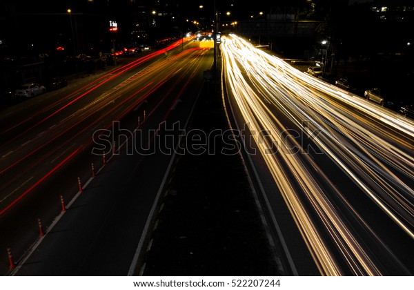 Speed traffic at are night\
time - lightr trails on motorway highway, long exposure and urban\
background
