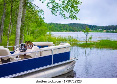 Speedboat on the background of a picturesque lake. Water recreation. Boating. Boat rental. Boat station. Water transport for walking.