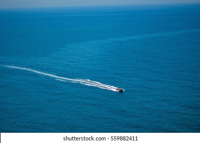 Speedboat On Water With White Trail