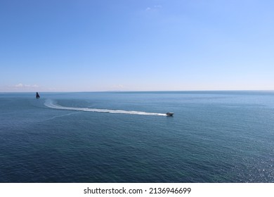 Speedboat and sailing boat on ocean