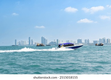 Speedboat sailing on the blue tropical sea on the background of Pattaya cityscape view and clear sky morning day at Koh Larn island. Speed boat running on the bay, Panorama ocean, Thailand, Vacation. - Powered by Shutterstock