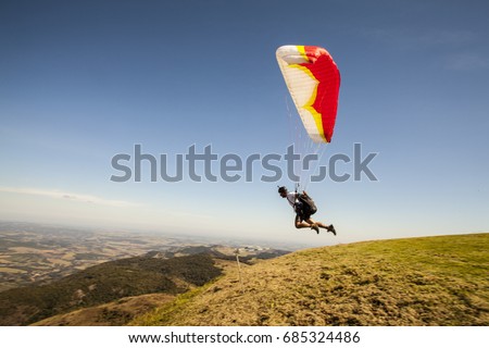 speedflying paraglider launching in sunny day, freedom concept.