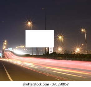 Speeding cars on modern Road infrastructure with blank hoarding for text messages, artistic long exposure shot - Shutterstock ID 370558859