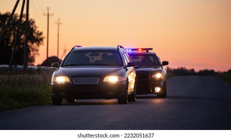 Speeding Driver Gets Pulled Over By Police Patrolling Car . Wide Shot of the Two Cars Stopped in a Road Crossing an Open Field. Drunk Driver Gets Caught by Professional Officers - Shutterstock ID 2232051637