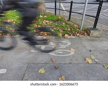 A speeding PURPOSELY to show fast motion) cyclist on a bicycle lane in Drumcondra, Dublin, Ireland