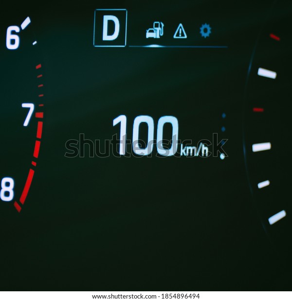 Speedometer in the car on the dashboard. The car\'s\
speedometer shows 100\
mph
