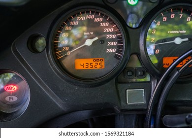 Speedometer Of Motorcycle On A Open Road From Rider Point Of View. Motorcycle Speedometer