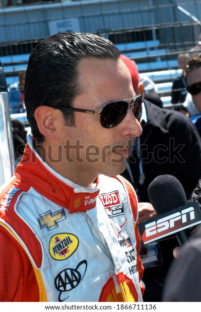 \
Speedway, IN, USA - May 24, 2013:\
Three-time Indy 500 winner Helio Castroneves gets interviewed\
during Carb Day practice for the 2013 Indy\
500.				