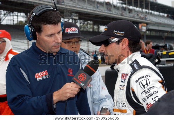 Speedway, IN, USA - May 27,\
2011:  IndyCar driver Alex Tagliani gets interviewed following\
practice on Carb Day before the Indy 500 at Indianapolis Motor\
Speedway.