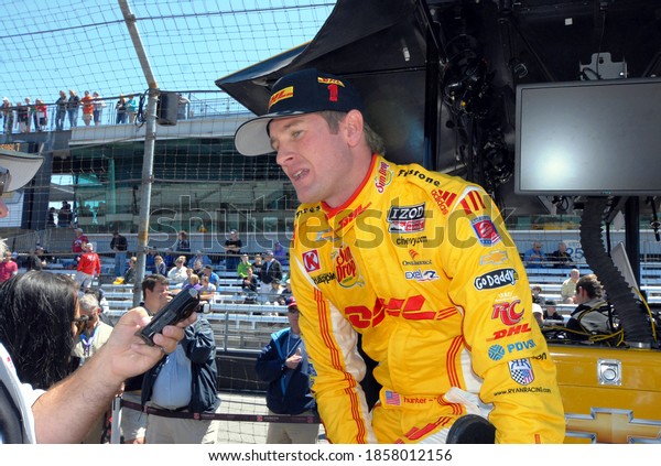 Speedway, IN/USA - May 24, 2013: Driver Ryan Hunter\
Reay gets interviewed during a break in Carb Day practice for the\
2013 Indy 500.