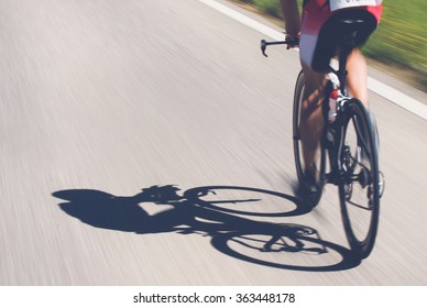 Speedy Shadow - A Cyclist At Top Speed On The Triathlon Race.